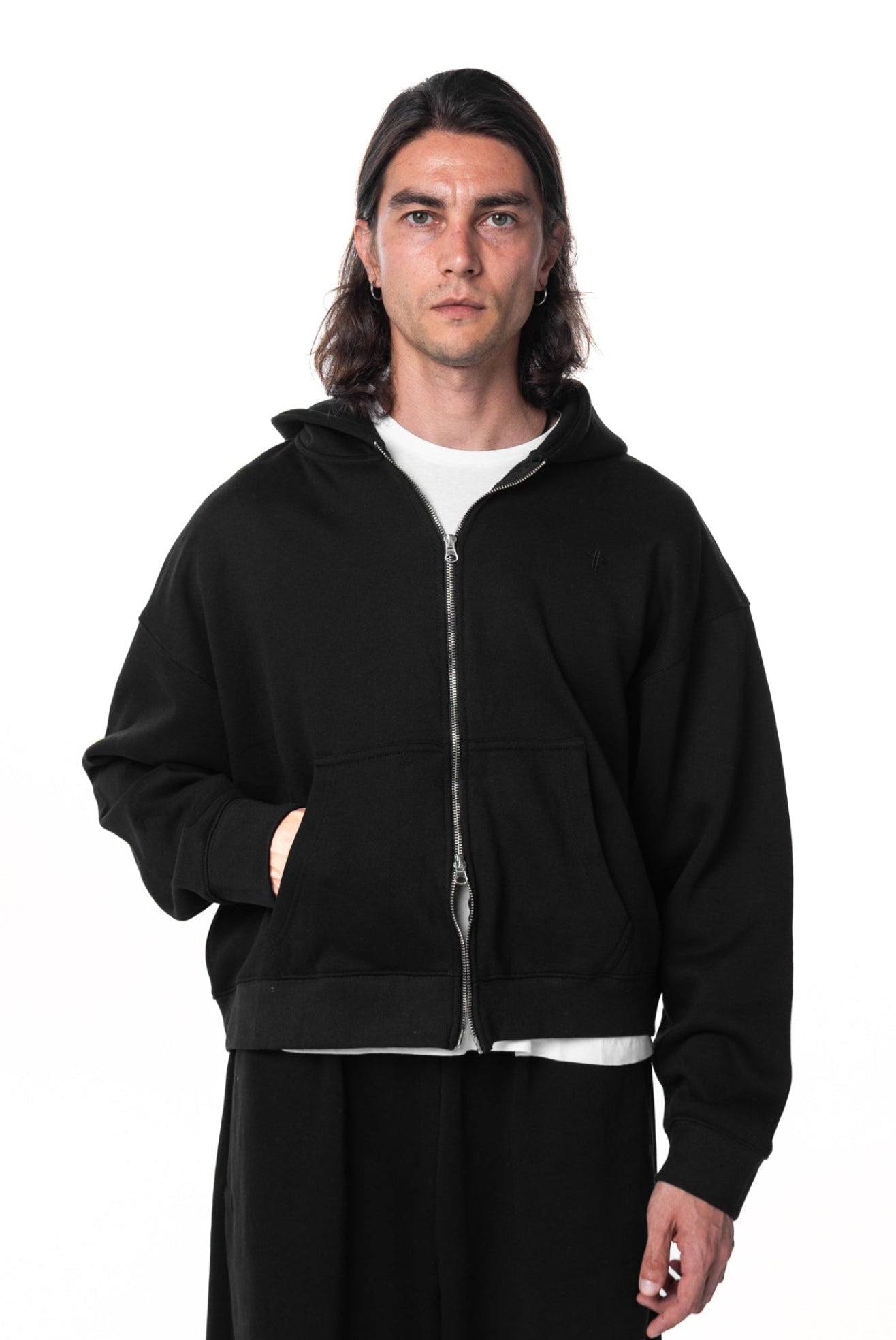 Person wearing a black hoodie on a white background