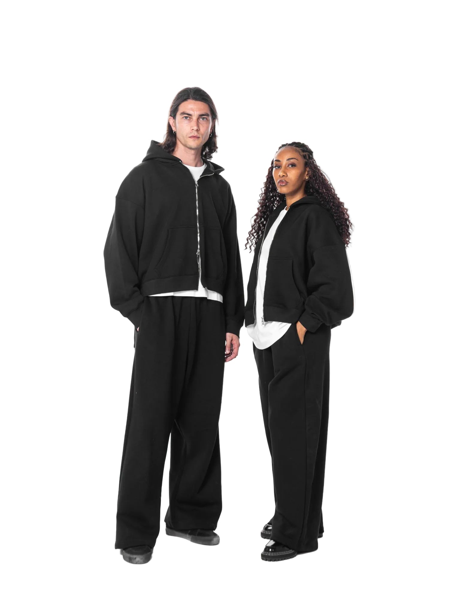 Two people wearing black tracksuits on a white background
