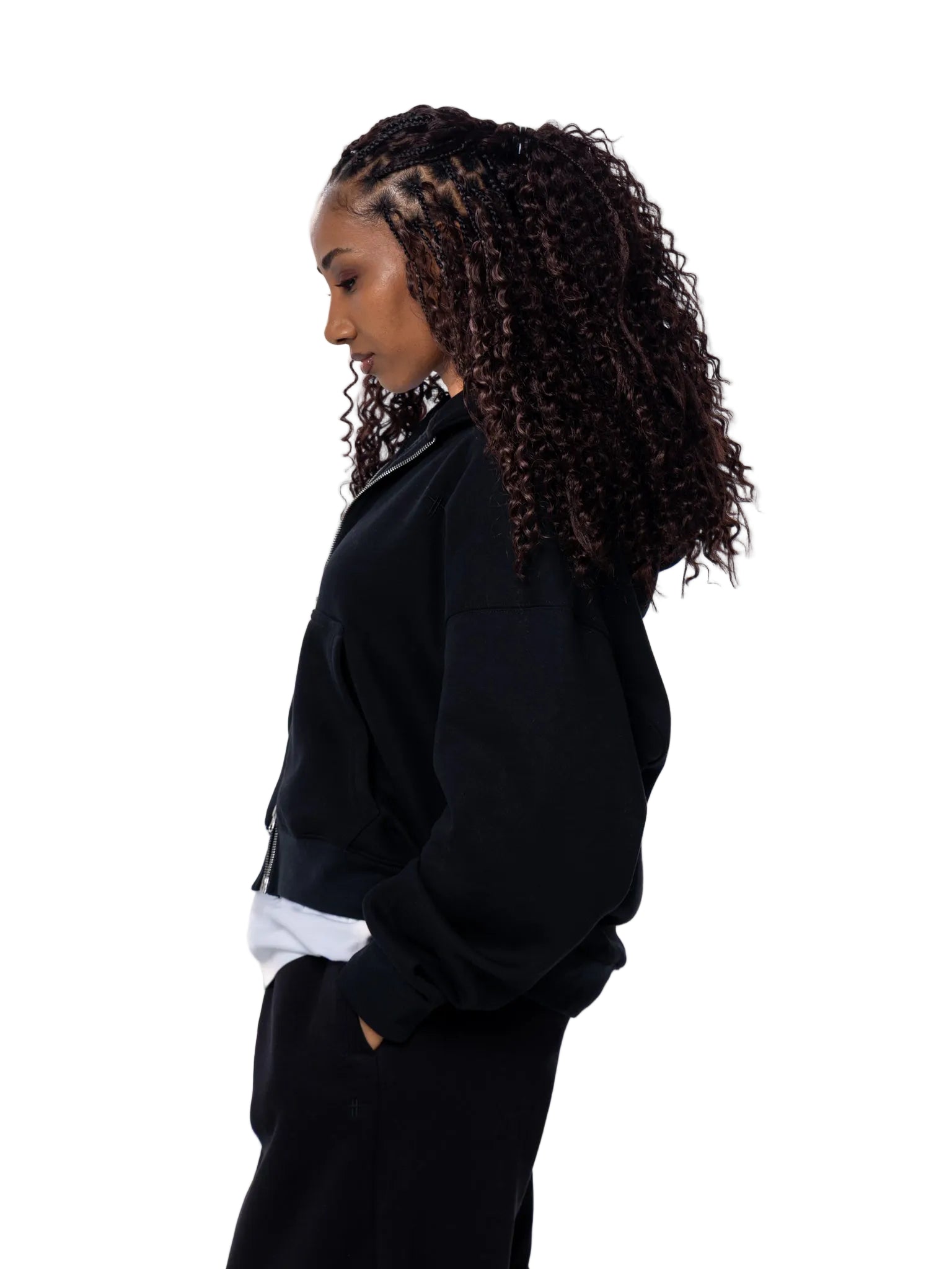 Person wearing a black jacket with a white shirt underneath on a white background