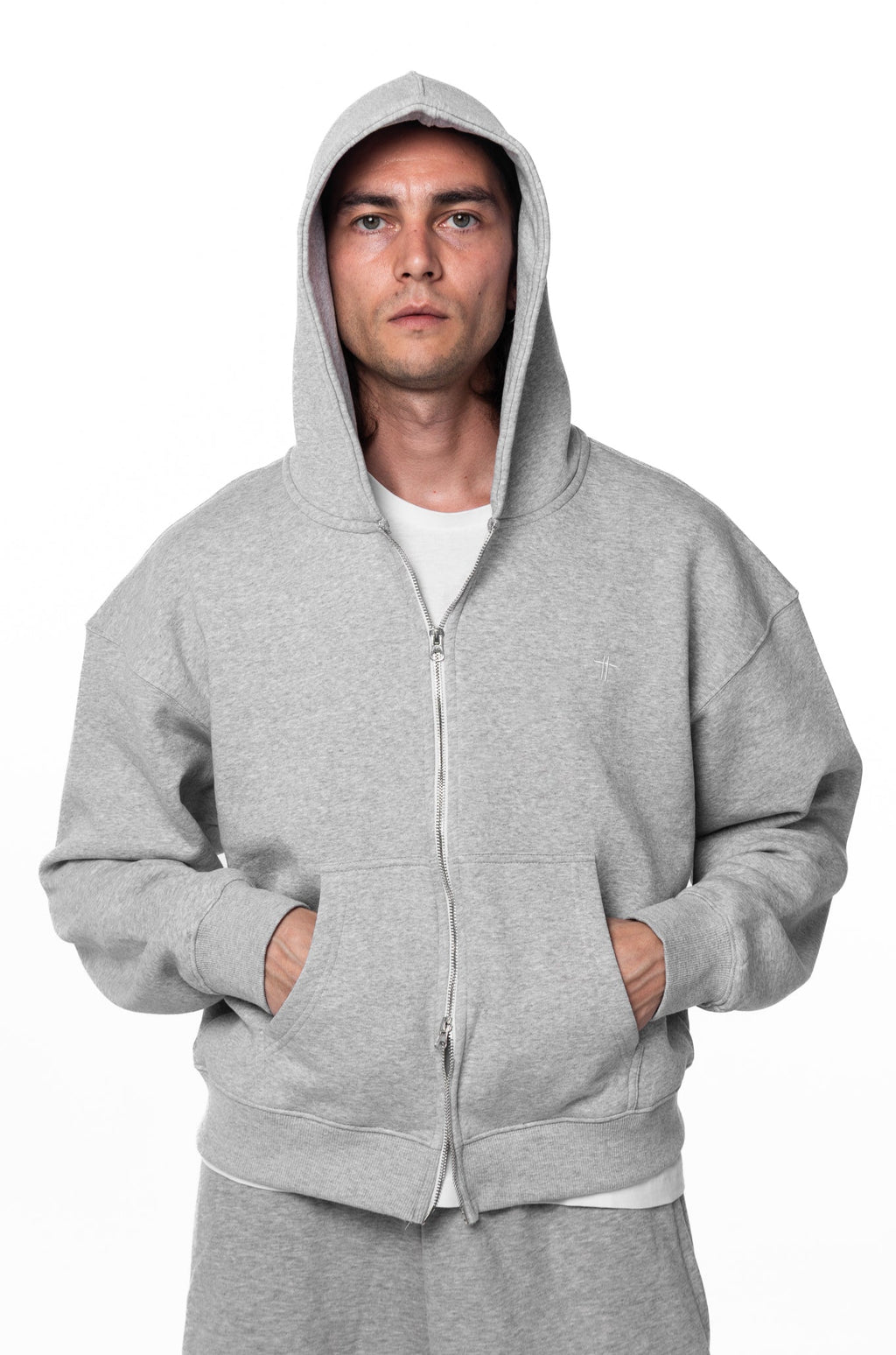 Person wearing a gray hoodie on a white background